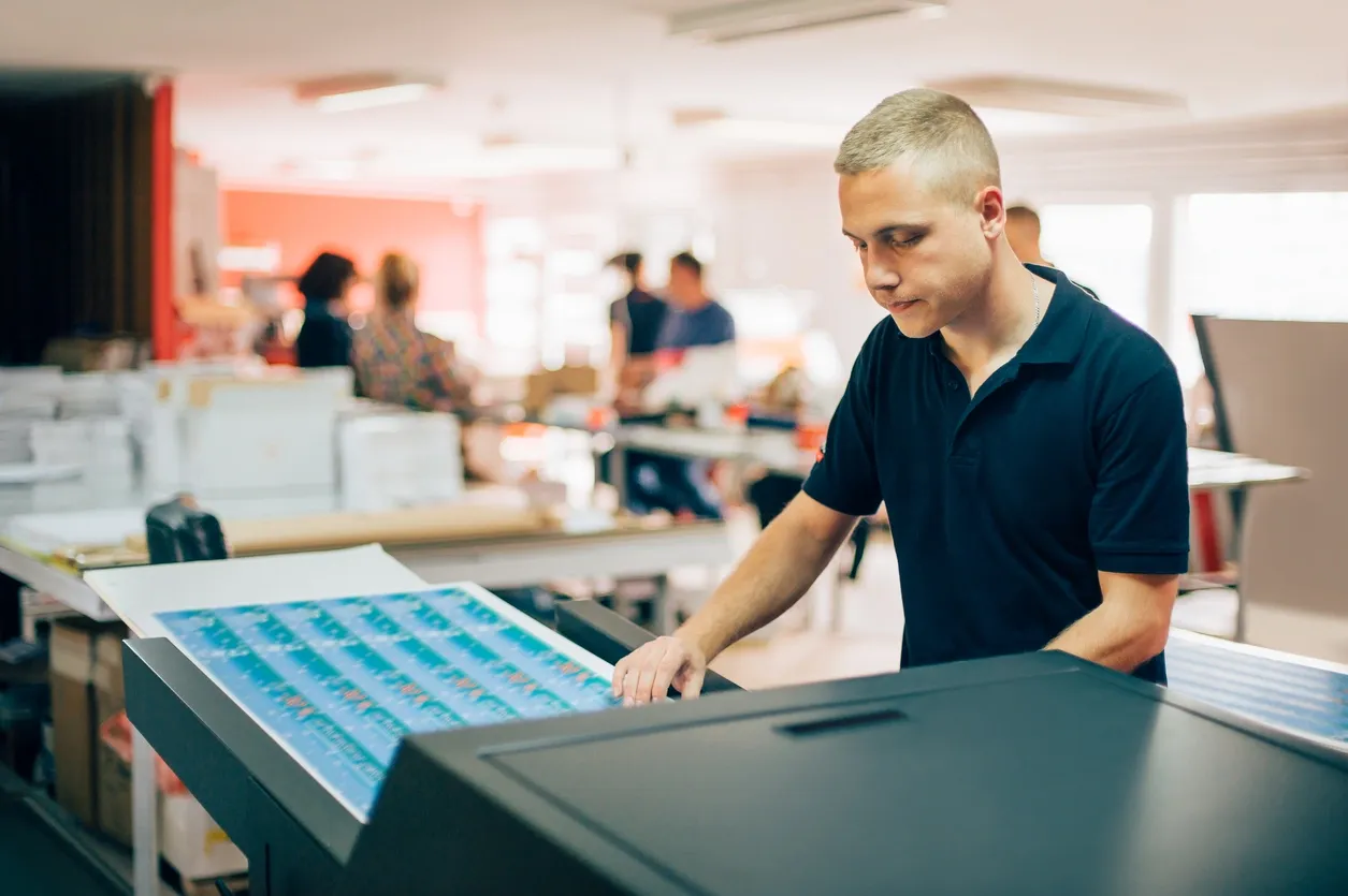 A man using a print machine